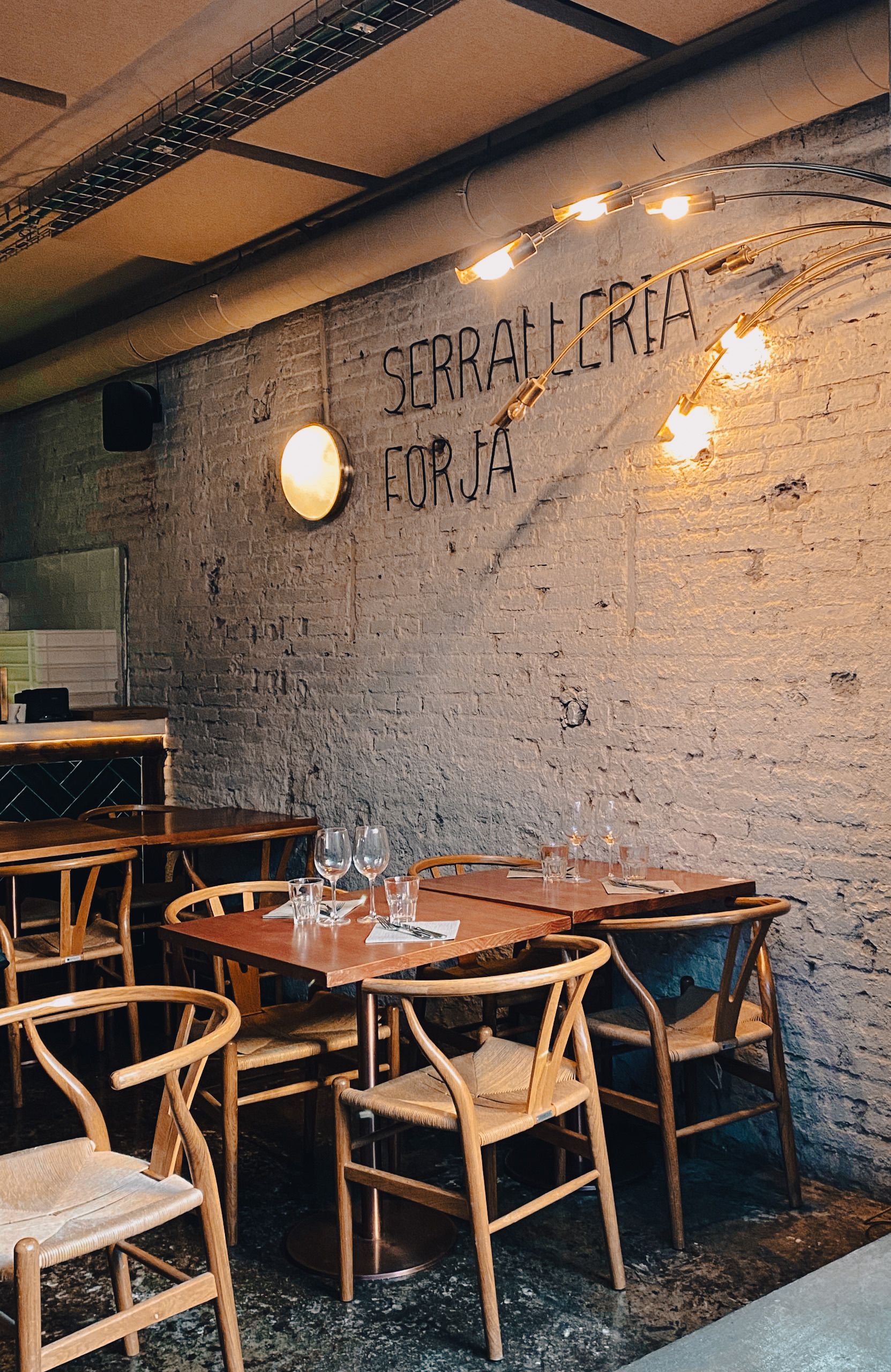 Inviting bohemian-style cafe with wooden chairs in Barcelona, Spain.