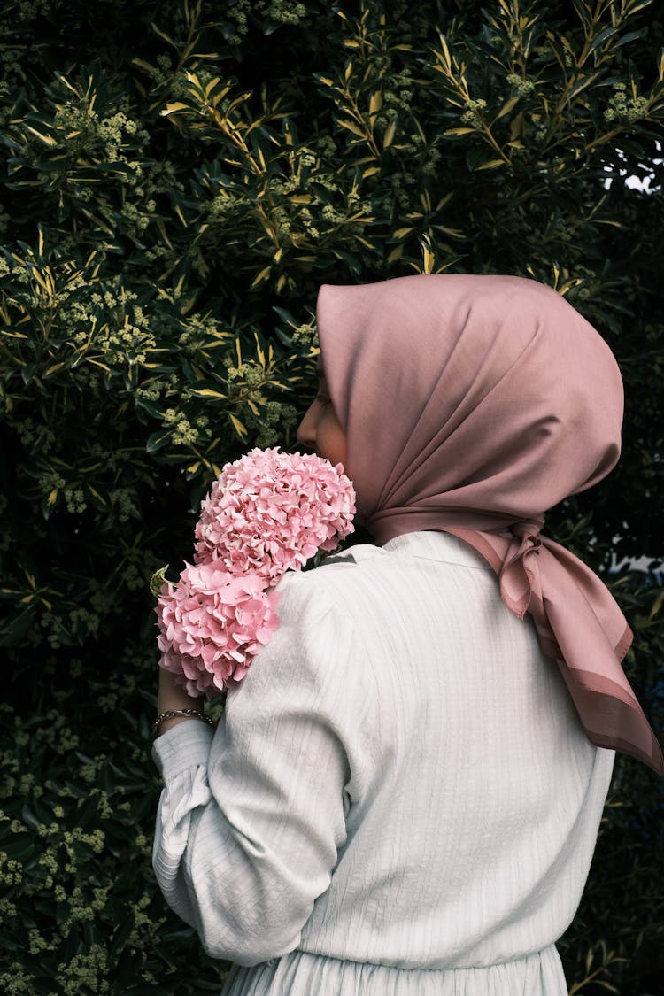 Hijabi Woman Hugging Bouquet Of Hydrangeas