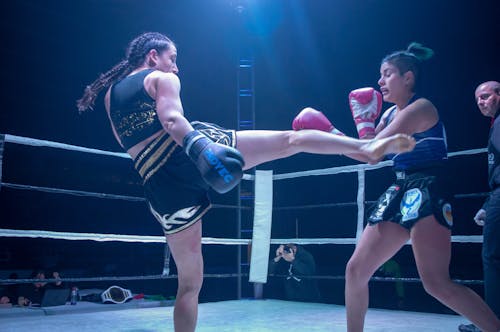 Free Two Women Kick Boxing in a Boxing Ring Stock Photo