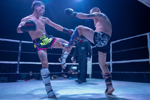 Free Two Men Kick Boxing in a Boxing Ring Stock Photo