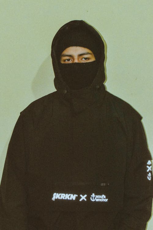 A Person in Black Hoodie and Mask