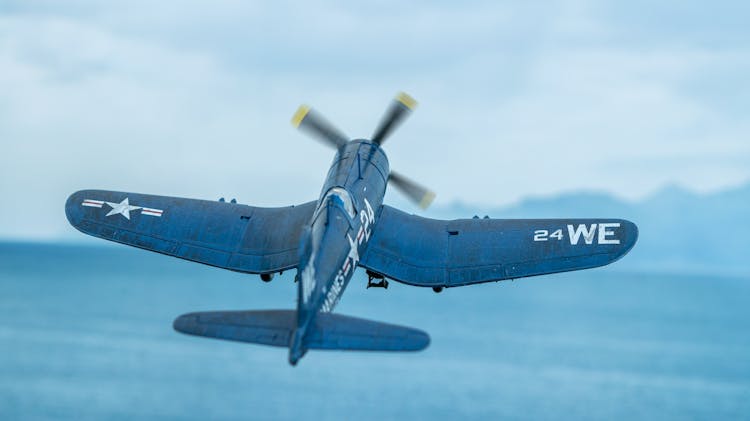 Diorama Of A F4U Corsair Scale Model Flying Over The Sea