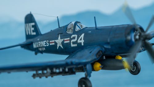 Free Diorama of a F4U Corsair scale model flying over the sea Stock Photo