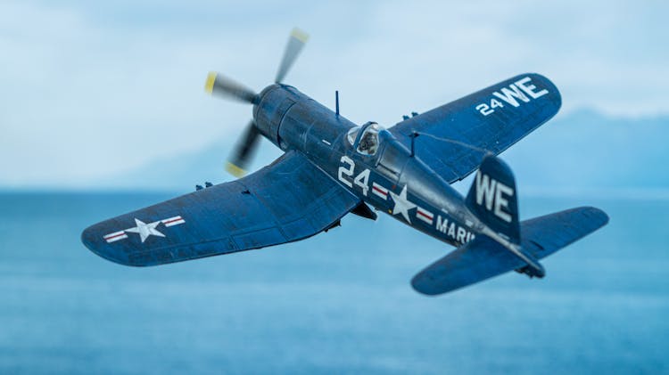 Diorama Of A F4U Corsair Scale Model Flying Over The Sea