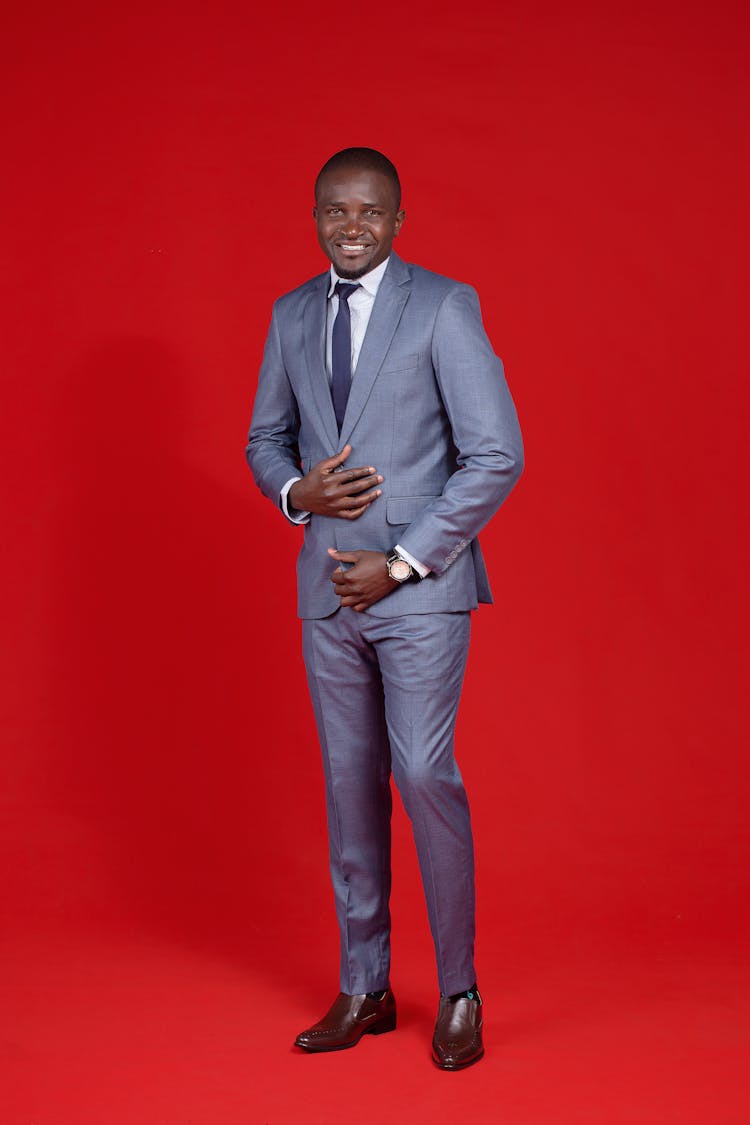 Smiling Man In Suit Posing In Studio