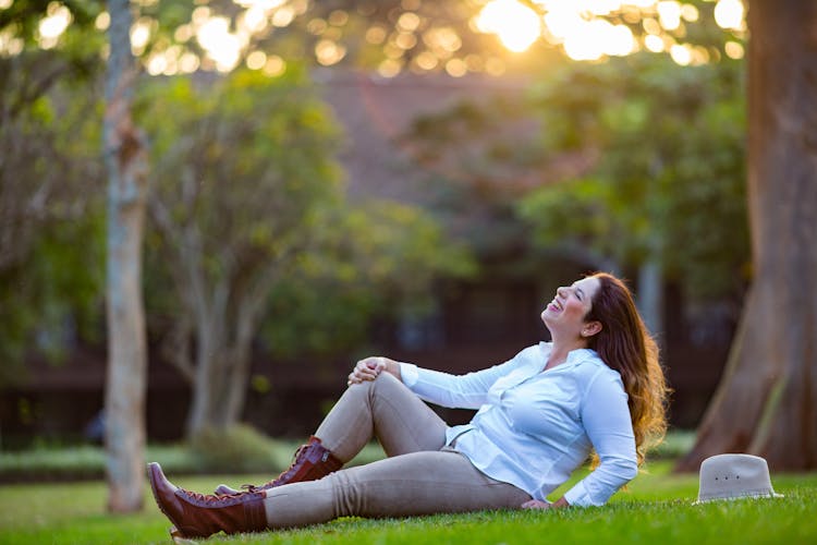 Smiling Woman Lying Down On Grass