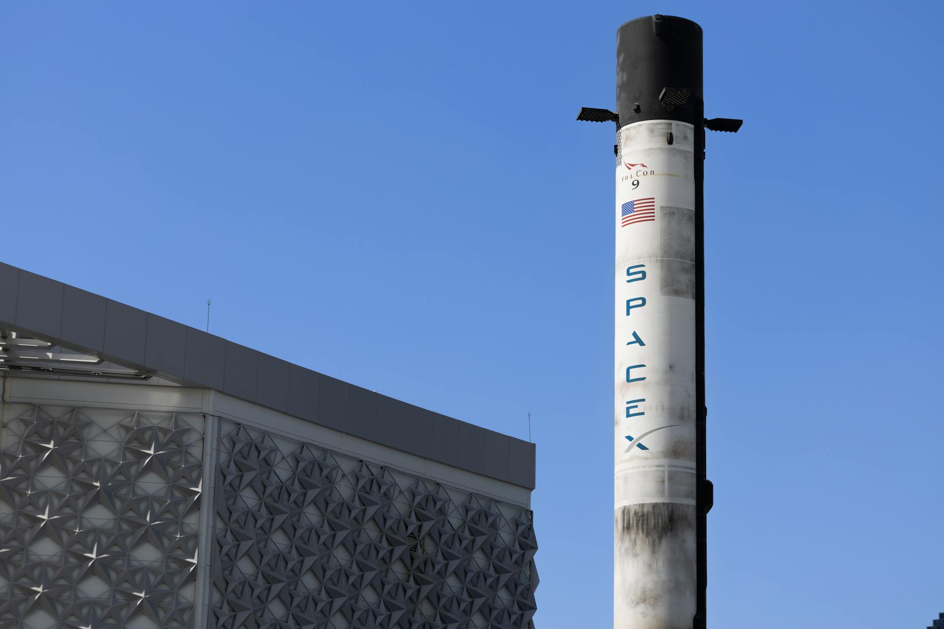 Space X Rocket and Building Exterior Against Blue Sky