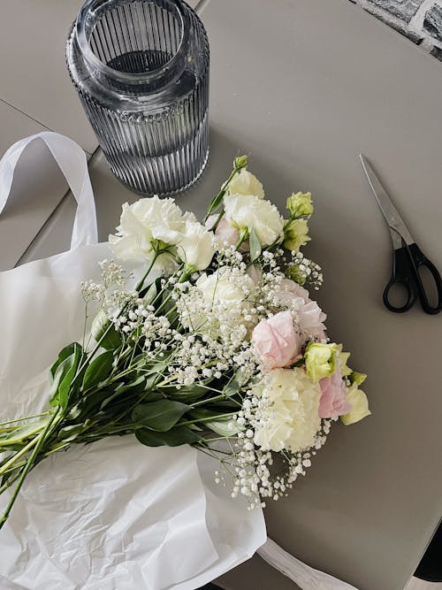 Bouquet of Flowers on a Table by a Vase and a Pair of Scissors