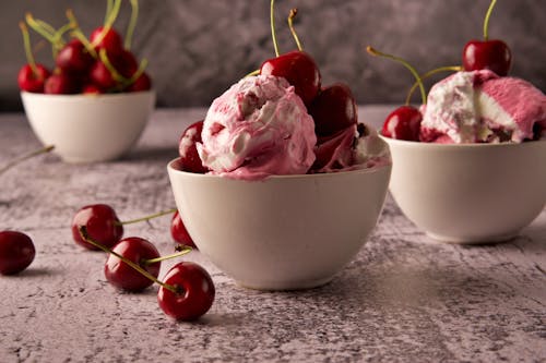 A Red Cherries with Ice Cream on a Ceramic Bowls