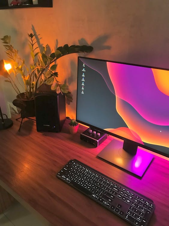 Black Computer Monitor and Black Computer Keyboard on Wooden Desk