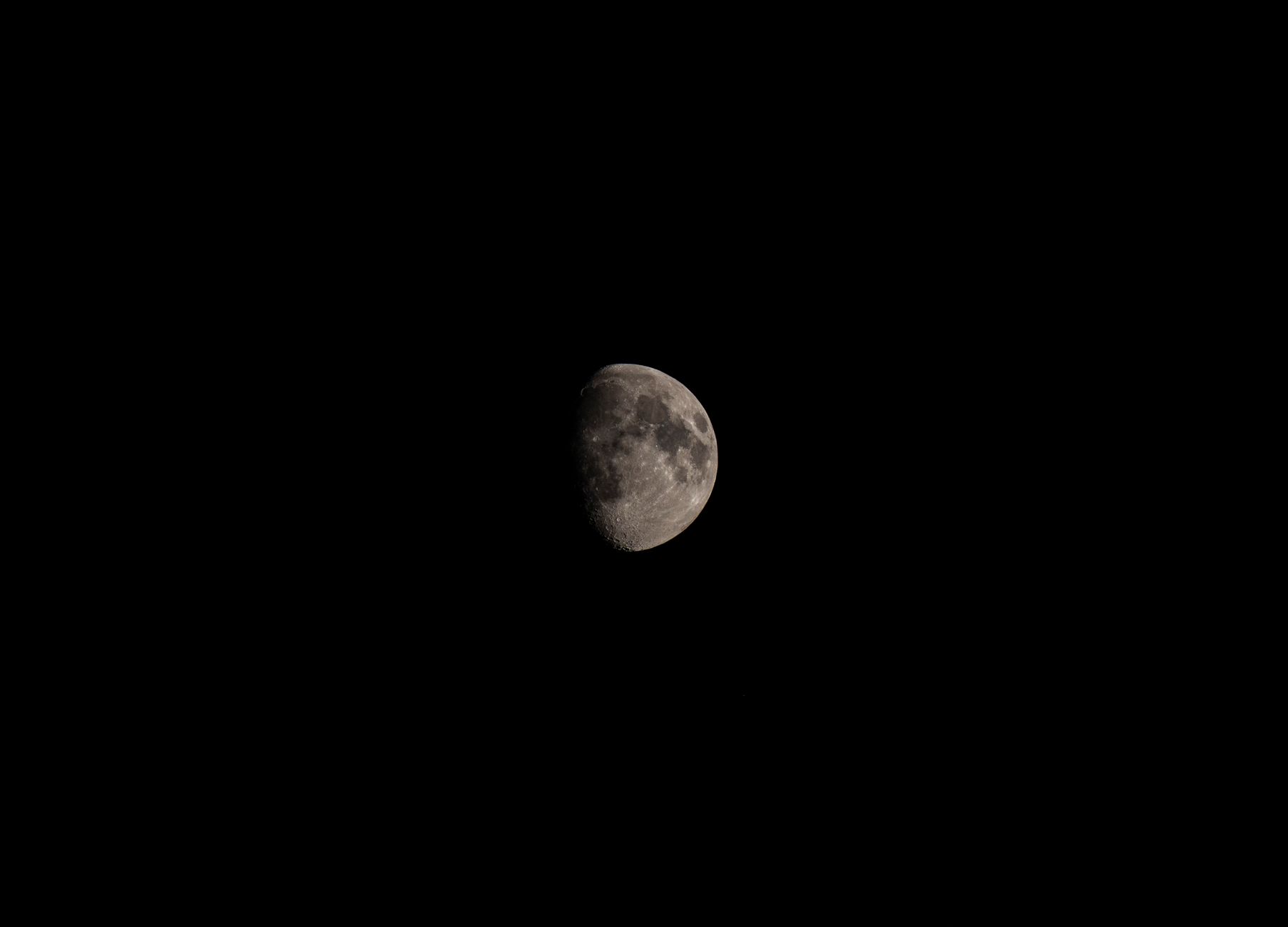 Detailed shot of the crescent moon illuminated against a clear, black night sky.