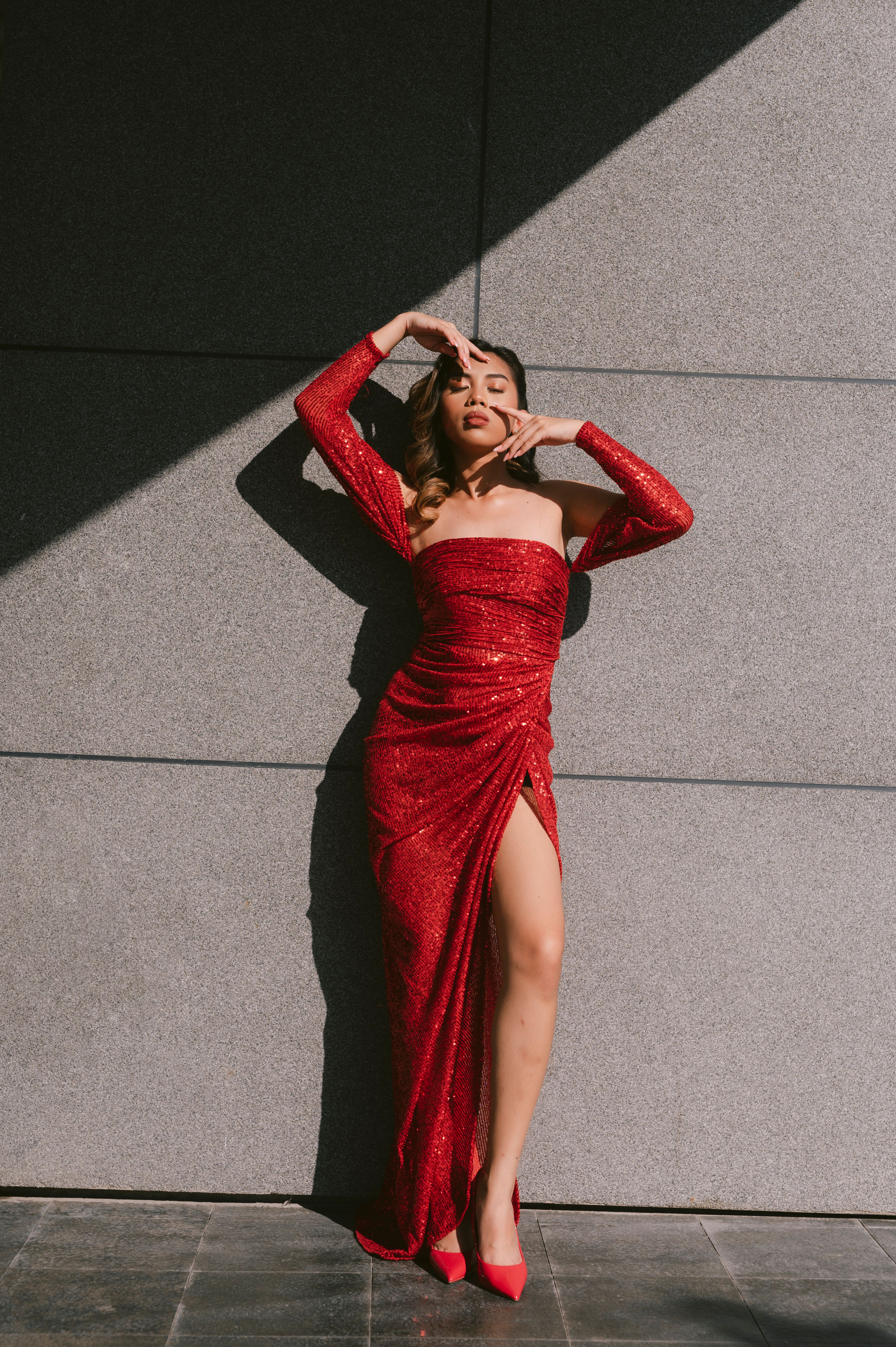 Woman in Red Dress Standing Beside a Wall · Free Stock Photo