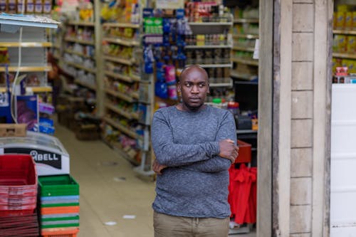 Free A Man in Gray Long Sleeves Standing Beside The Grocery Store Stock Photo
