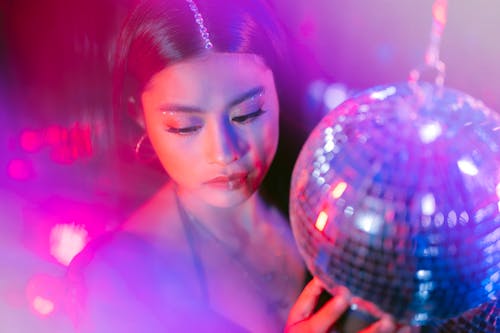 A Woman Holding a Disco Ball