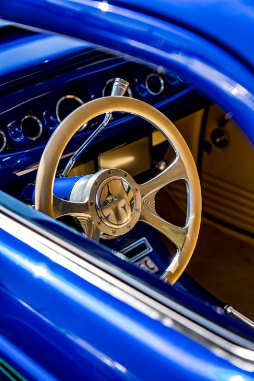 Free Nostalgic close-up of a vintage car's steering wheel and dashboard, capturing classic design details. Stock Photo