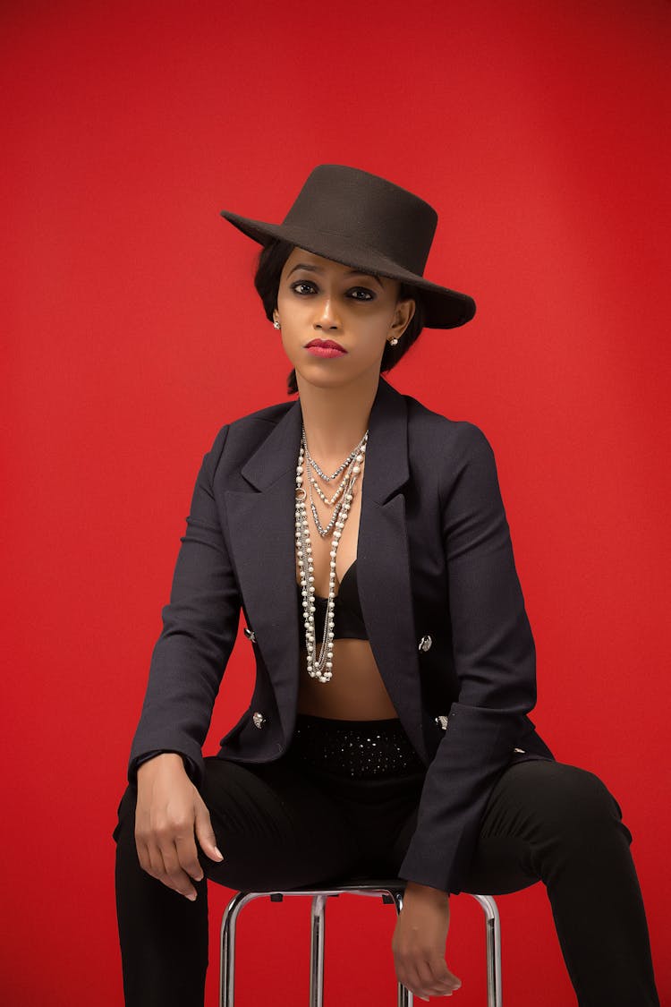 Elegant Woman Wearing Hat And Jewelry In Studio