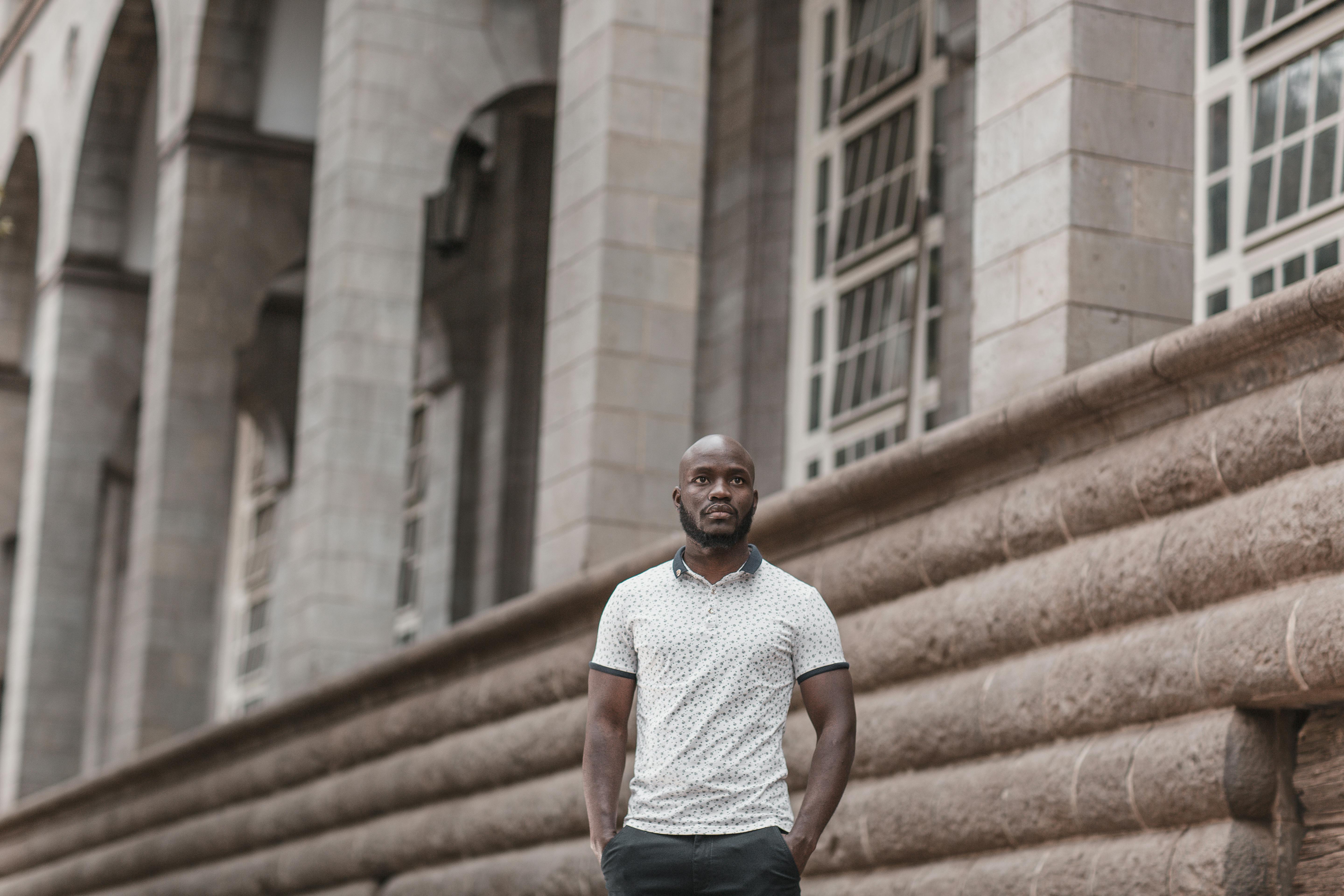 photo of a standing man with hands in pockets