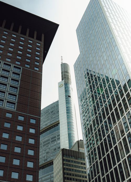 Free Dramatic cityscape featuring towering modern skyscrapers with reflective glass facades. Stock Photo