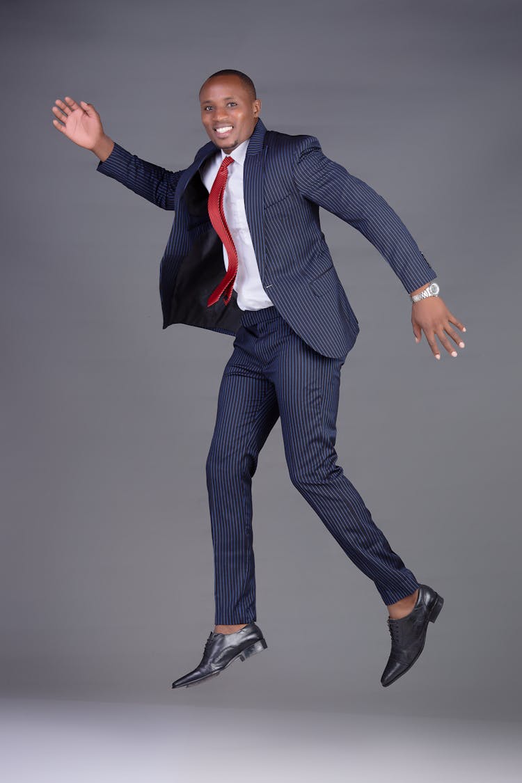 Man In Striped Suit Jumping