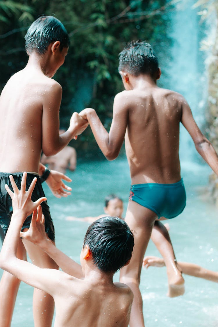 Kids Swimming On A Stream