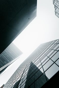 View of towering skyscrapers with modern architecture against a bright sky.