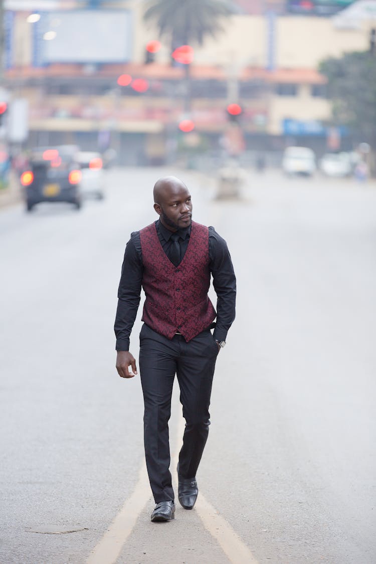 Man In Black Shirt Walking On Road