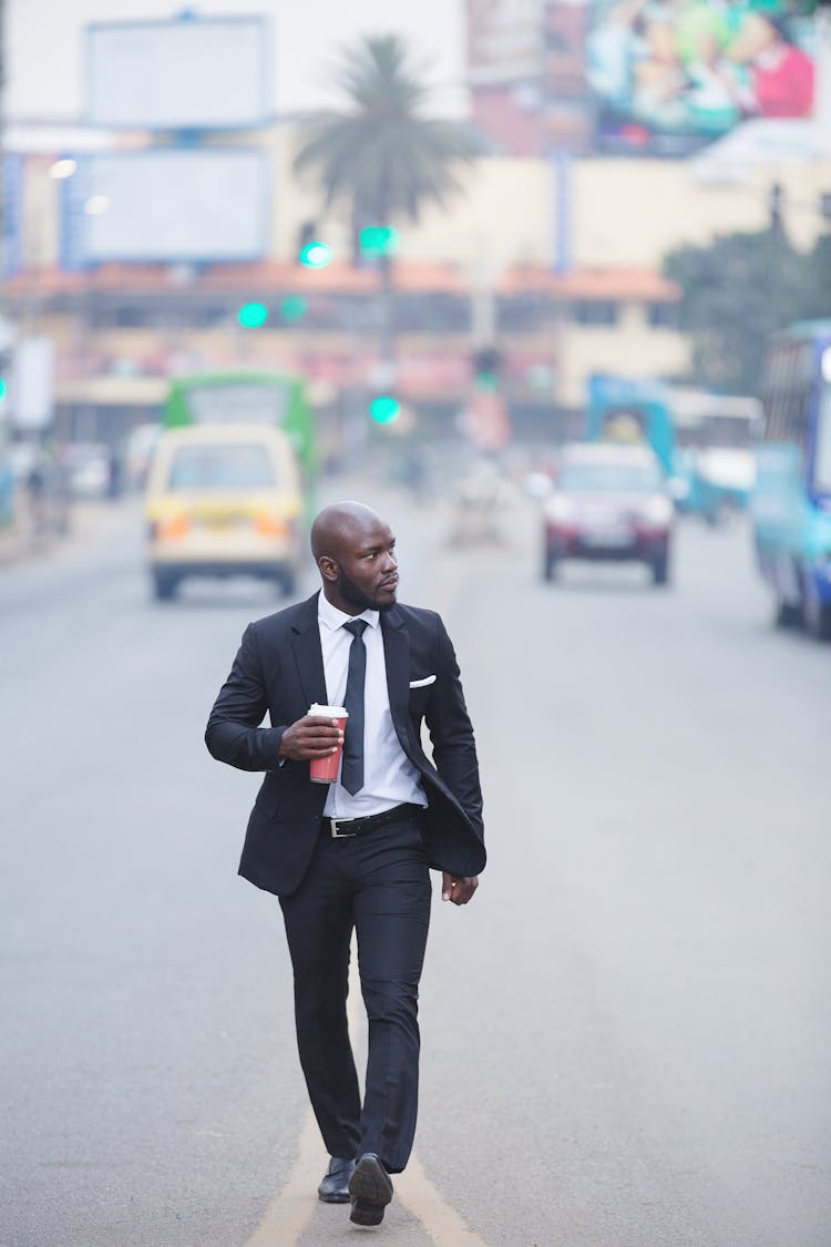 Man In Suit Walking On Street