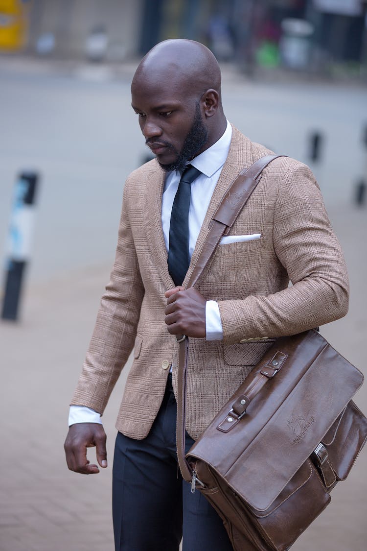 Man In A Suit Walking With A Bag