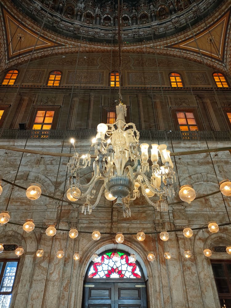 Chandelier In A Cathedral And Rows Of Lights