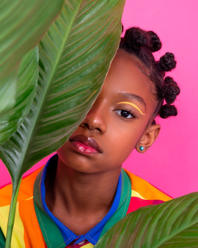 Girl Posing Behind Plant Leaves 