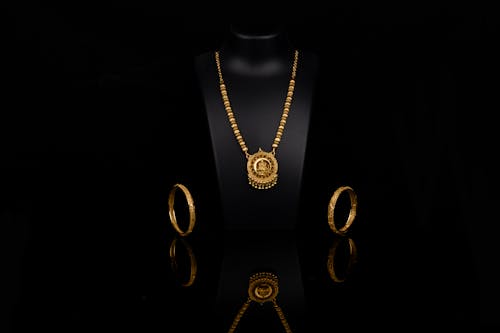  Golden Necklace and Rings with Black Background