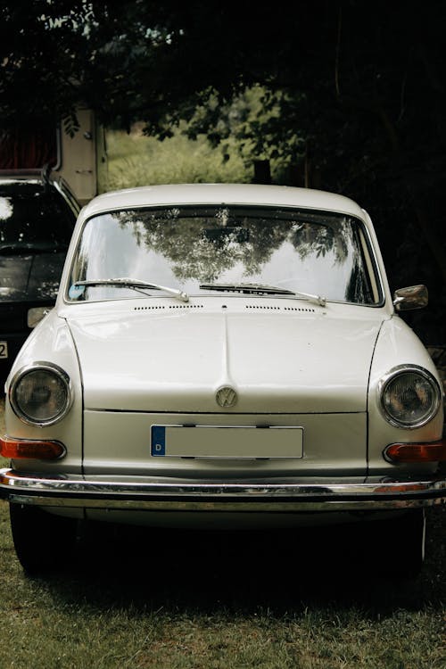 Vintage White Volkswagen Parked on Green Grass
