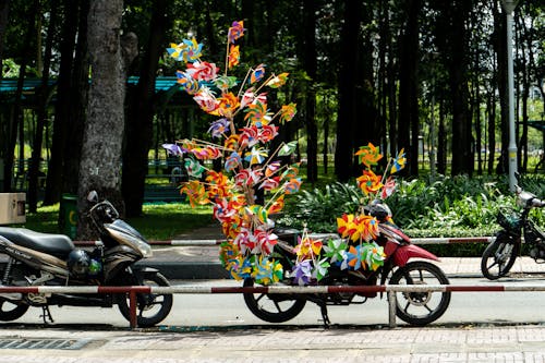 Plastic Windmill Toys on a Parked Motorcycle