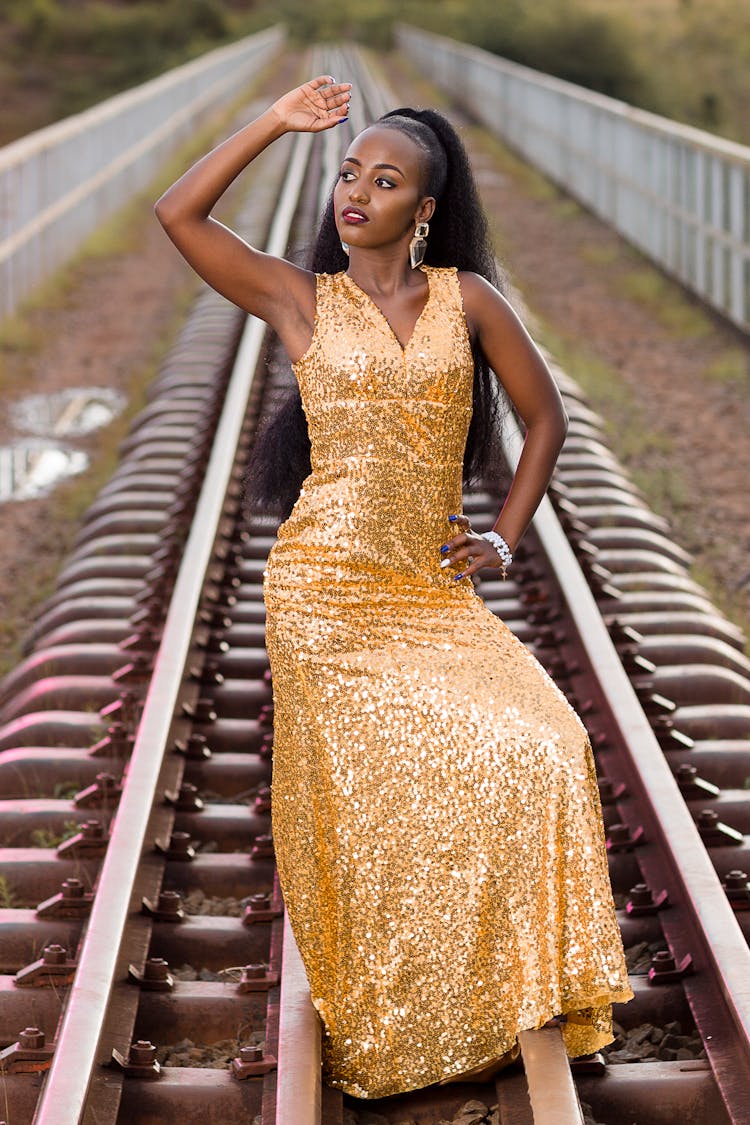 Alluring Woman In Sparkling Gold Dress 