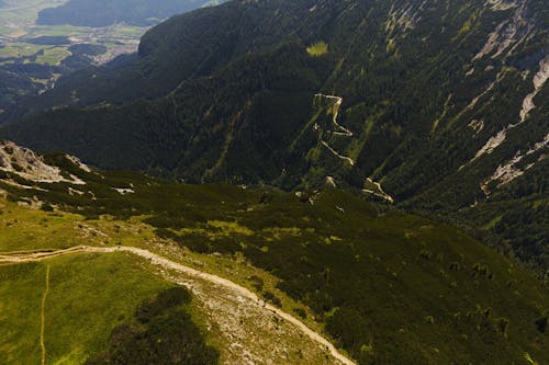 An Aerial Photography of Green Grass Field Near the Mountain