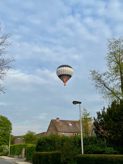 Black and White Hot Air Balloon on Mid Air Under Cloudy Sky