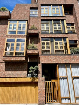 Low angle view of a modern residential brick building with wooden accents.