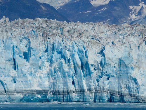 Free Stunning view of an Alaskan glacier with rugged mountains in the background, illustrating nature's beauty. Stock Photo