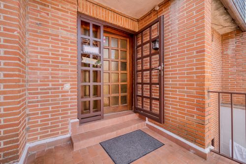 Free Inviting entrance of a brick house featuring a classic wooden door and steps, perfect for real estate listings. Stock Photo
