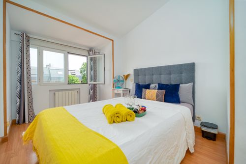Free Contemporary bedroom interior with a bright yellow theme and a comfortable bed. Stock Photo