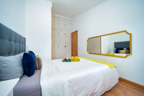 Free Elegant bedroom interior featuring minimalist design with cozy accents and a spacious layout. Stock Photo