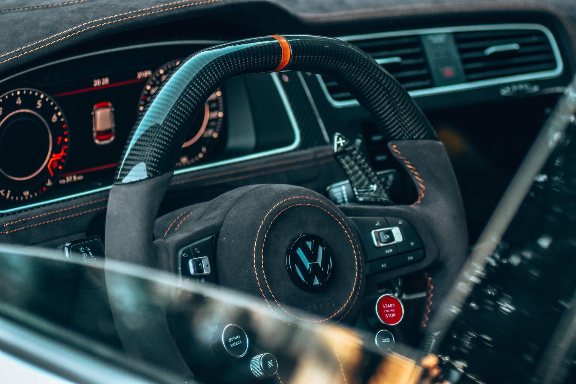 Detailed view of Volkswagen car interior showcasing steering wheel and dashboard.
