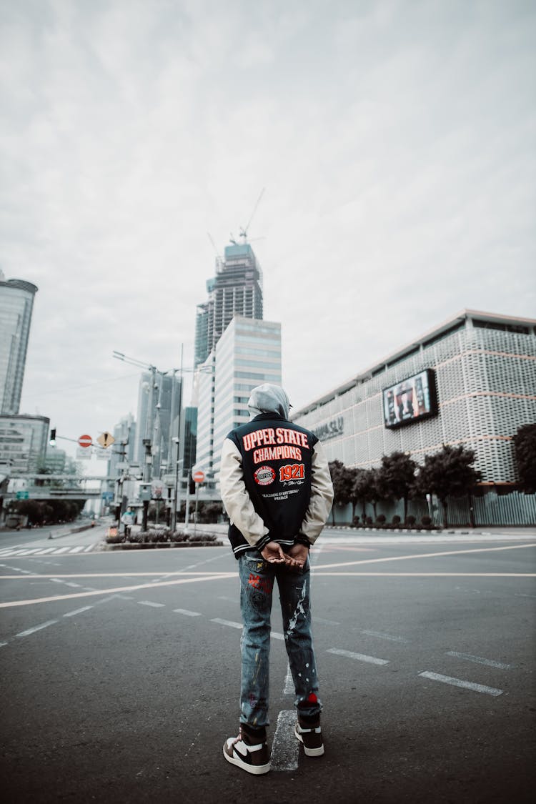 Back Of A Man Standing On A Street