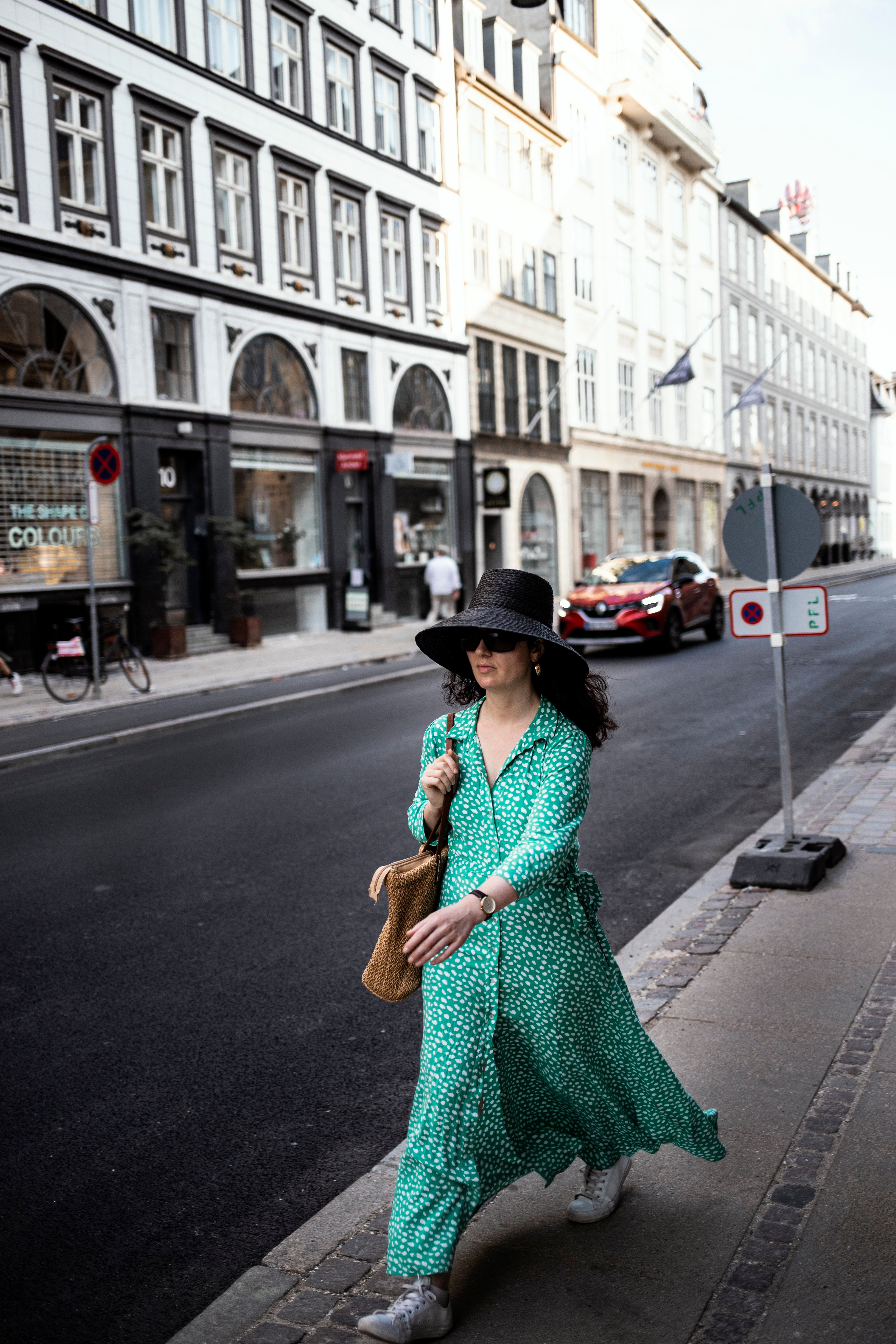A Woman in Green Dress Walking on the Street · Free Stock Photo