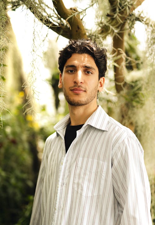 A Bearded Man in Striped Long Sleeves Looking with a Serious Face