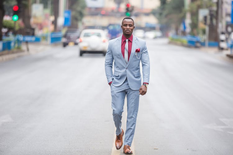 Good Looking Man In Suit Walking On The Road