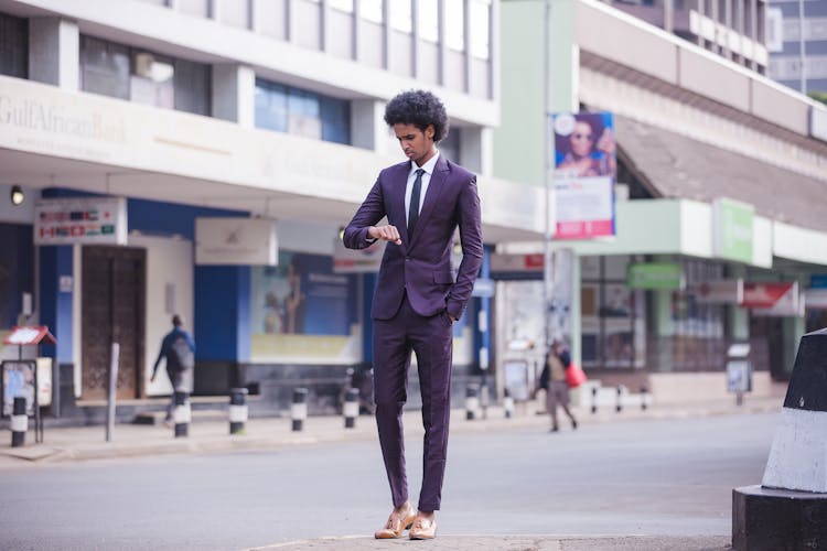 Man Wearing A Suit Looking At The Time