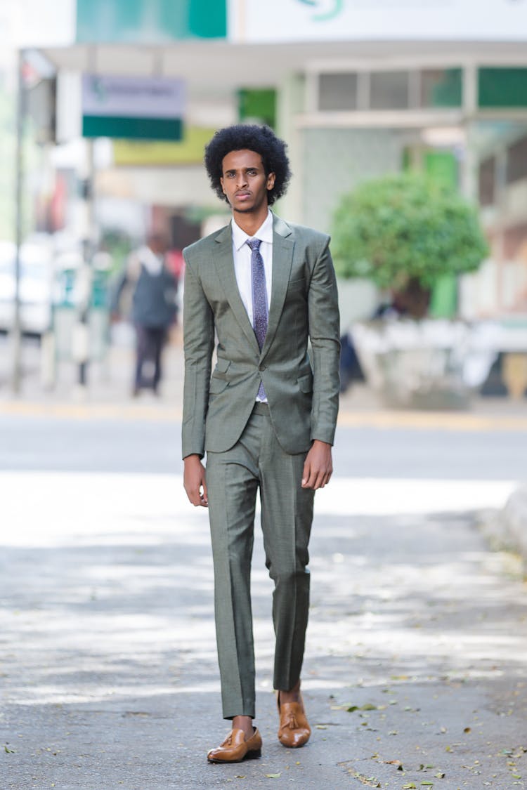 A Tall Man Wearing A Green Suit