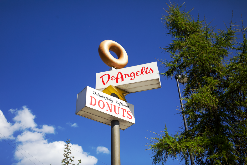 Retro donut shop sign with clear blue sky background in Copenhagen, Denmark.