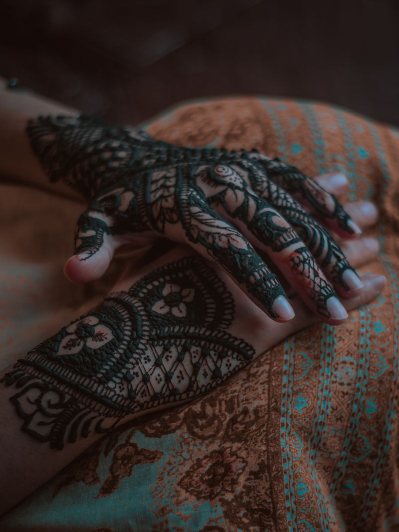 Hands decorated with intricate mehndi patterns